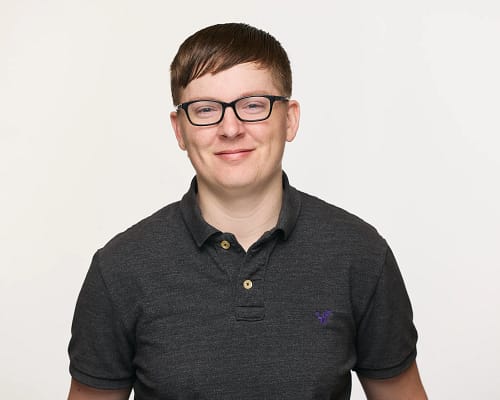 Headshot of Amie wearing a dark grey polo