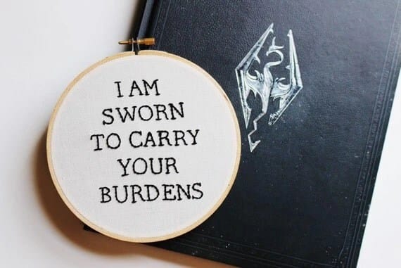 Cross Stitch that says "I am sworn to carry your burdens" is reference to the OG companion, Lydia, in The Elder Scrolls V: Skyrim.